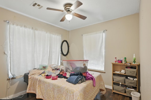 1142 Rte F, Anderson, MO 64831 - bedroom featuring multiple windows, wood finished floors, baseboards, and ceiling fan