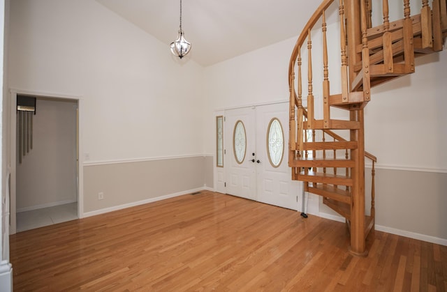 1603 W Northwood St, Bolivar, MO 65613 - foyer entrance featuring stairs, high vaulted ceiling, light wood-style floors, and baseboards