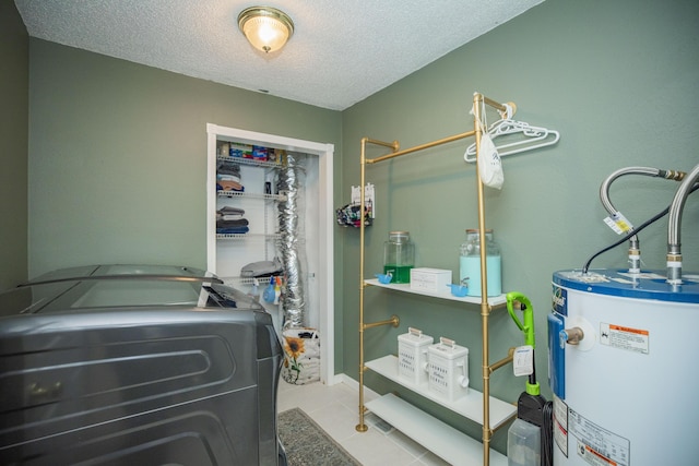 1603 W Northwood St, Bolivar, MO 65613 - laundry room with gas water heater, washing machine and clothes dryer, a textured ceiling, and tile patterned flooring