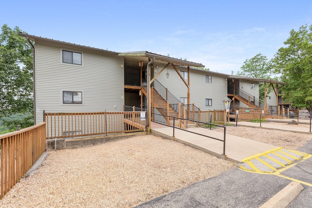 550 Notch Ln Unit 2, Reeds Spring, MO 65737 - rear view of property with stairs and uncovered parking