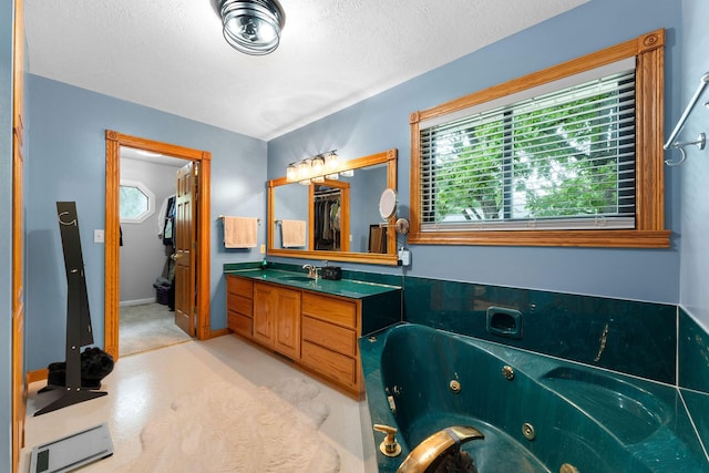 25158 Autumn View Dr, Shell Knob, MO 65747 - bathroom featuring plenty of natural light, vanity, a jetted tub, and a textured ceiling