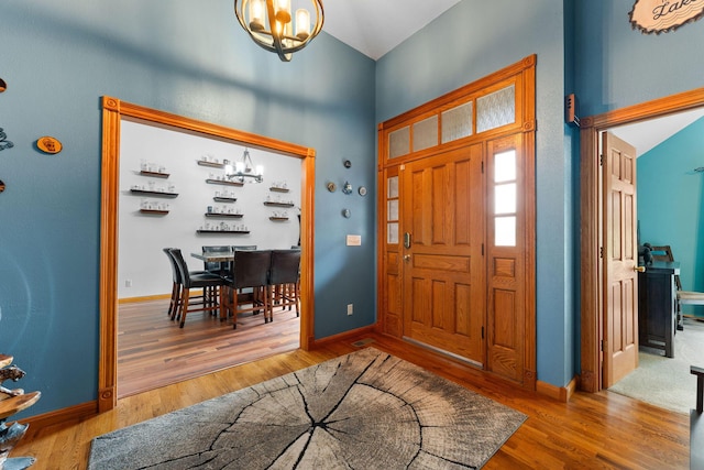 25158 Autumn View Dr, Shell Knob, MO 65747 - foyer entrance with a chandelier, wood finished floors, baseboards, and high vaulted ceiling