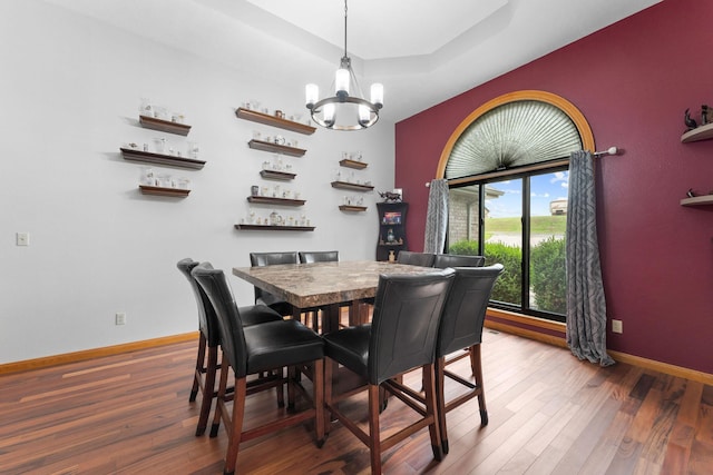25158 Autumn View Dr, Shell Knob, MO 65747 - dining space featuring a chandelier, wood finished floors, baseboards, and a raised ceiling