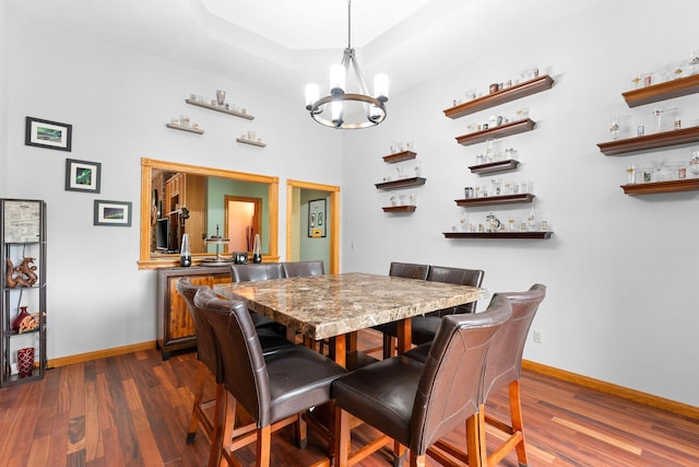 25158 Autumn View Dr, Shell Knob, MO 65747 - dining area featuring baseboards, a chandelier, dark wood finished floors, and a raised ceiling