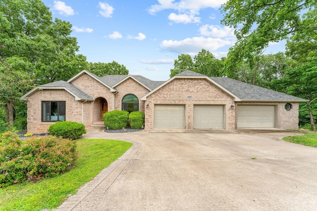 25158 Autumn View Dr, Shell Knob, MO 65747 - view of front of house with concrete driveway, a garage, brick siding, and roof with shingles