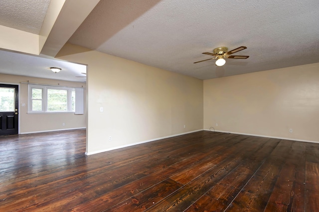 801 N 11th Ave, Ozark, MO 65721 - unfurnished room with dark wood-type flooring, a textured ceiling, ceiling fan, and baseboards