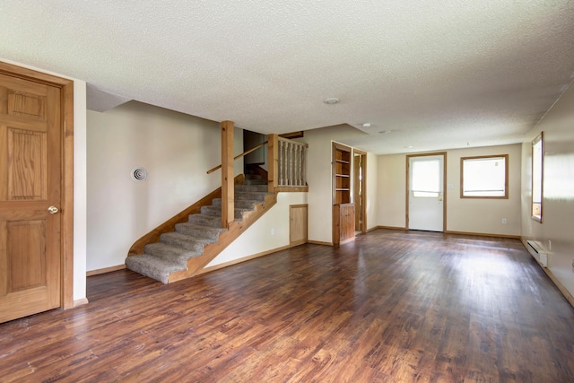 801 N 11th Ave, Ozark, MO 65721 - unfurnished living room featuring a textured ceiling, wood finished floors, baseboards, and stairway