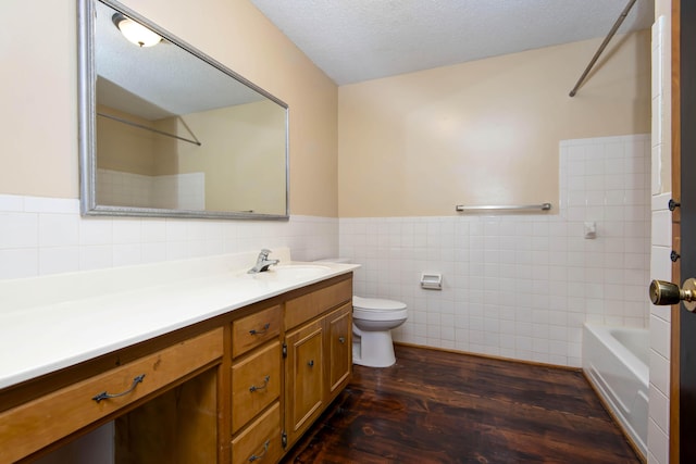801 N 11th Ave, Ozark, MO 65721 - bathroom featuring tile walls, vanity, wood finished floors, toilet, and wainscoting
