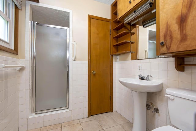 801 N 11th Ave, Ozark, MO 65721 - full bathroom with tile walls, a shower stall, toilet, tile patterned flooring, and a wainscoted wall