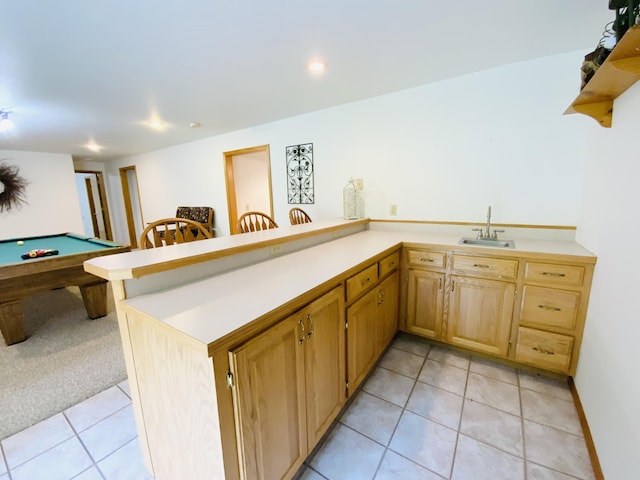 540 S Hickory Dr, Springfield, MO 65809 - kitchen featuring light tile patterned floors, light countertops, a sink, a peninsula, and open shelves