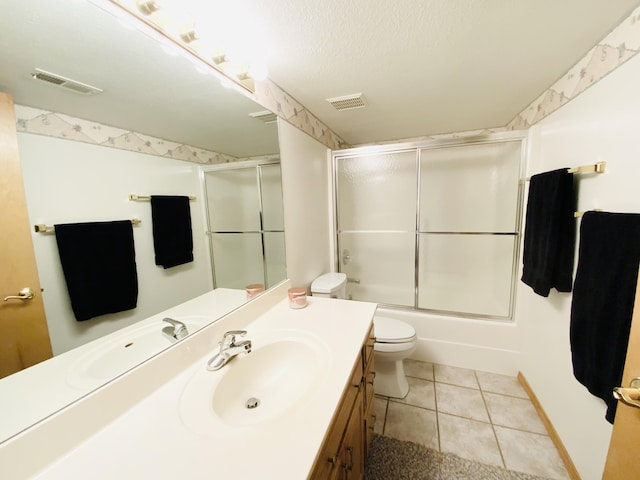 540 S Hickory Dr, Springfield, MO 65809 - bathroom featuring vanity, toilet, tile patterned floors, and shower / bath combination with glass door