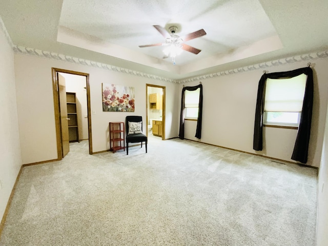 540 S Hickory Dr, Springfield, MO 65809 - sitting room with a tray ceiling, a ceiling fan, light colored carpet, and baseboards