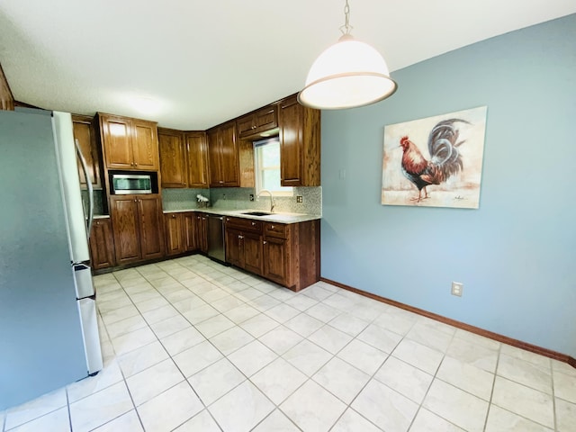 540 S Hickory Dr, Springfield, MO 65809 - kitchen featuring appliances with stainless steel finishes, light countertops, a sink, tasteful backsplash, and baseboards