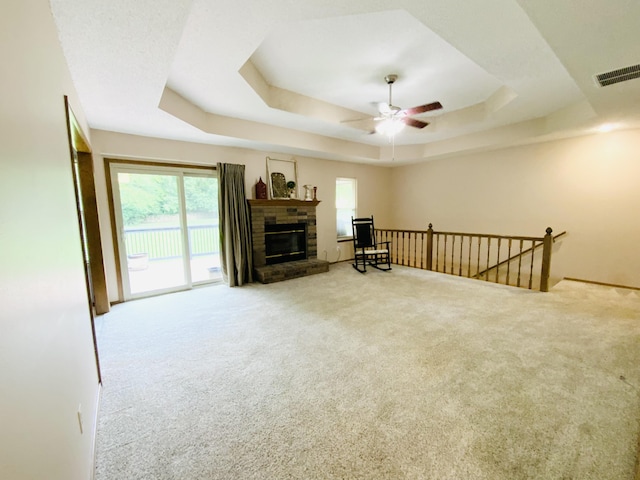 540 S Hickory Dr, Springfield, MO 65809 - carpeted living room featuring a tray ceiling, a ceiling fan, and a glass covered fireplace