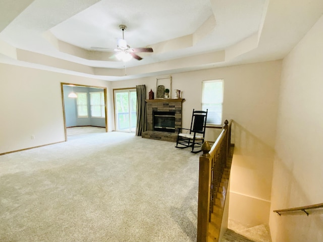 540 S Hickory Dr, Springfield, MO 65809 - living area featuring a tray ceiling, a ceiling fan, carpet, and a fireplace