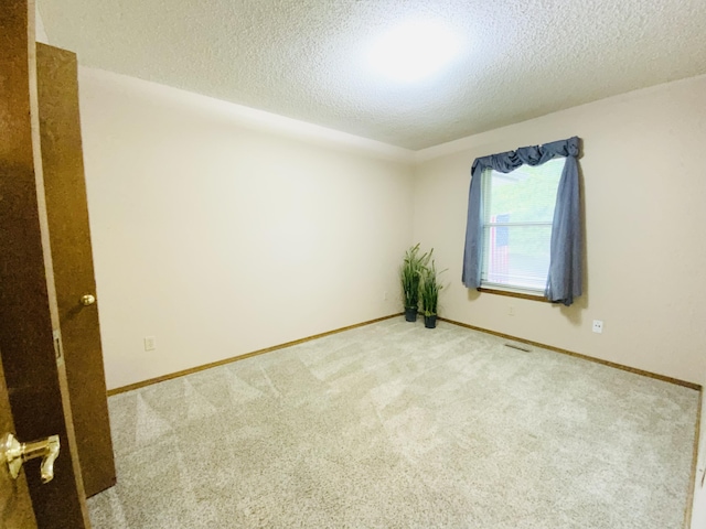 540 S Hickory Dr, Springfield, MO 65809 - spare room featuring a textured ceiling, carpet floors, and baseboards
