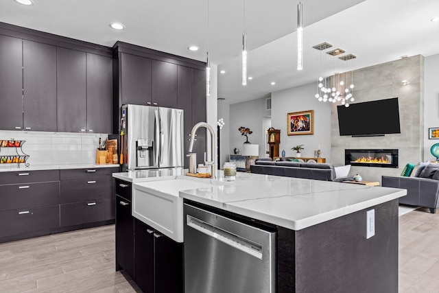 518 N Dublin Dr, Nixa, MO 65714 - kitchen with appliances with stainless steel finishes, a sink, open floor plan, recessed lighting, and an island with sink