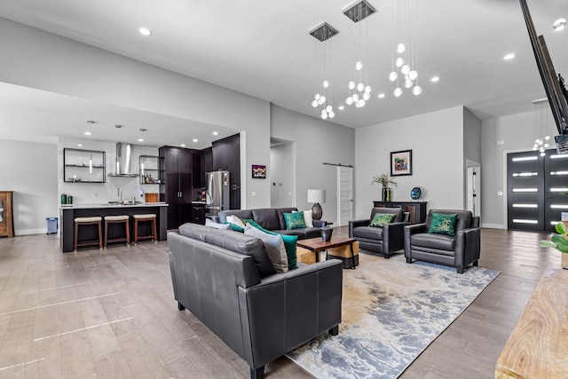 518 N Dublin Dr, Nixa, MO 65714 - living area with a barn door, recessed lighting, and light wood-style flooring