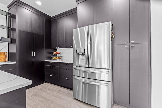 518 N Dublin Dr, Nixa, MO 65714 - kitchen featuring stainless steel fridge, light stone countertops, and light wood-style floors