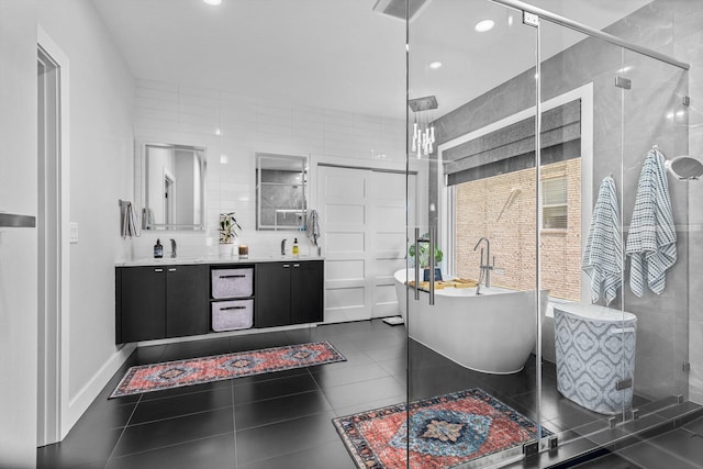 518 N Dublin Dr, Nixa, MO 65714 - bathroom featuring double vanity, a stall shower, a freestanding bath, recessed lighting, and tile patterned flooring