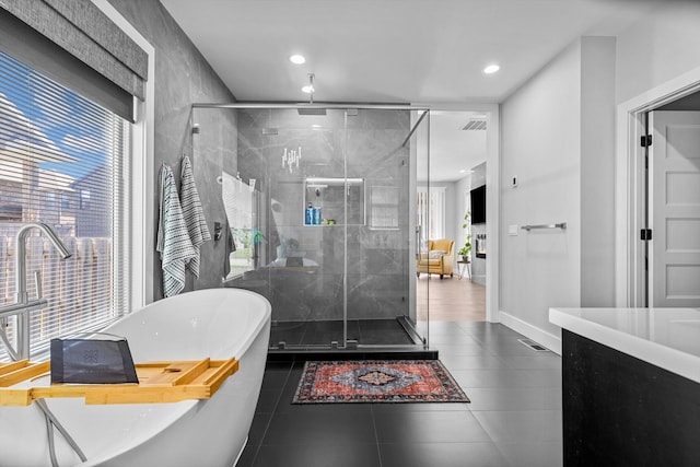 518 N Dublin Dr, Nixa, MO 65714 - bathroom featuring healthy amount of natural light, a stall shower, a freestanding tub, and recessed lighting