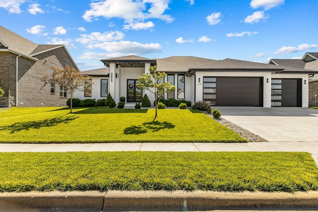 518 N Dublin Dr, Nixa, MO 65714 - prairie-style home featuring an attached garage, concrete driveway, a front lawn, and stucco siding