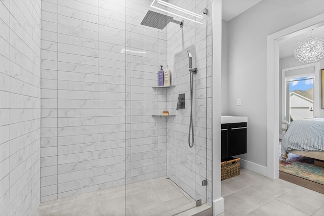 518 N Dublin Dr, Nixa, MO 65714 - ensuite bathroom featuring tiled shower, a chandelier, vanity, and tile patterned floors