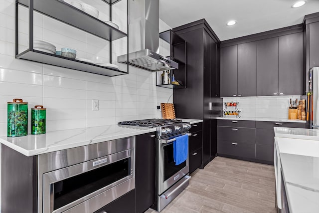518 N Dublin Dr, Nixa, MO 65714 - kitchen featuring appliances with stainless steel finishes, wall chimney exhaust hood, backsplash, light stone countertops, and recessed lighting