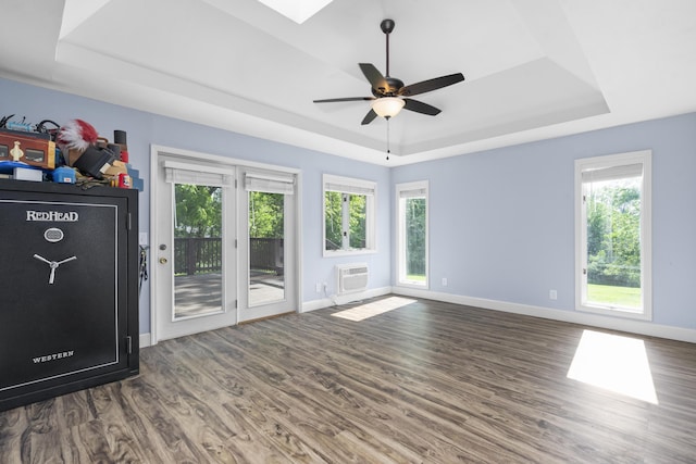 4159 N Farm Rd Unit 173, Springfield, MO 65803 - unfurnished living room with a raised ceiling, wood finished floors, plenty of natural light, and baseboards