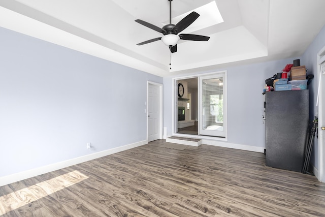 4159 N Farm Rd Unit 173, Springfield, MO 65803 - unfurnished room with a raised ceiling, dark wood-type flooring, ceiling fan, baseboards, and a skylight