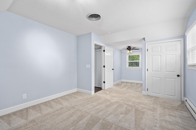 4159 N Farm Rd Unit 173, Springfield, MO 65803 - unfurnished bedroom with a baseboard heating unit, carpet floors, baseboards, and vaulted ceiling