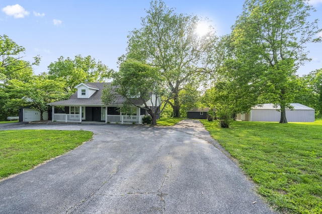 4159 N Farm Rd Unit 173, Springfield, MO 65803 - view of front of property featuring asphalt driveway, a porch, a front lawn, and a shingled roof