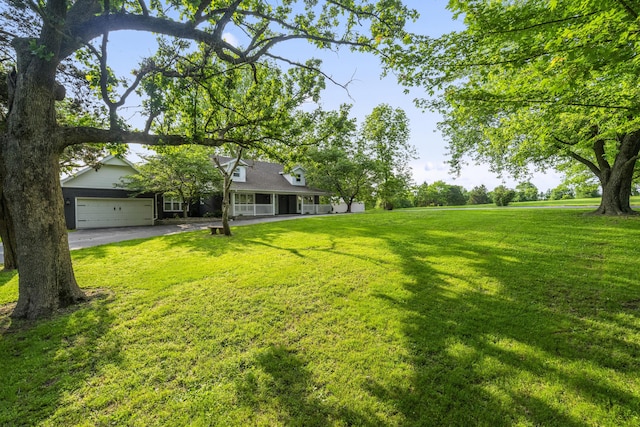 4159 N Farm Rd Unit 173, Springfield, MO 65803 - view of green lawn with a porch, a garage, and driveway