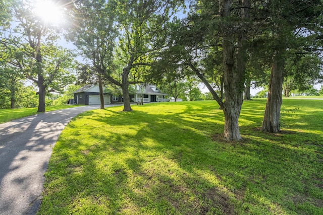 4159 N Farm Rd Unit 173, Springfield, MO 65803 - view of front facade with asphalt driveway, a front yard, and an attached garage
