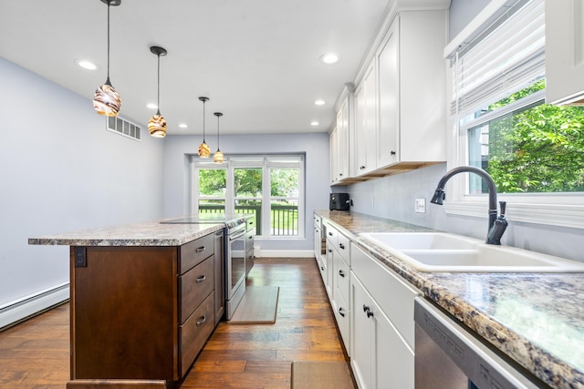 4159 N Farm Rd Unit 173, Springfield, MO 65803 - kitchen featuring a sink, stainless steel appliances, a center island, a baseboard heating unit, and white cabinets
