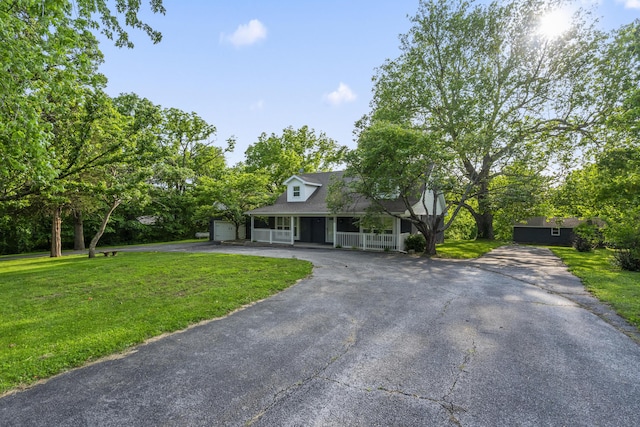 4159 N Farm Rd Unit 173, Springfield, MO 65803 - new england style home featuring a porch, asphalt driveway, a front yard, and a shingled roof