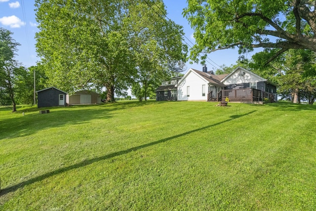 4159 N Farm Rd Unit 173, Springfield, MO 65803 - view of green lawn with a wooden deck and an outdoor structure