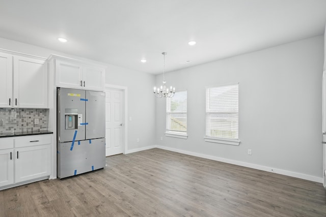 406 Barton Pl, Neosho, MO 64850 - kitchen featuring fridge with ice dispenser, dark countertops, a chandelier, light wood-style floors, and recessed lighting