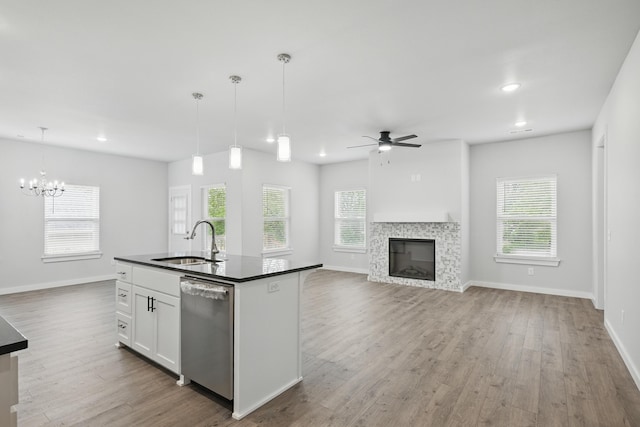 406 Barton Pl, Neosho, MO 64850 - kitchen with dishwasher, a sink, dark countertops, ceiling fan, and wood finished floors