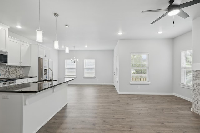 406 Barton Pl, Neosho, MO 64850 - kitchen with dark countertops, appliances with stainless steel finishes, a sink, recessed lighting, and open floor plan