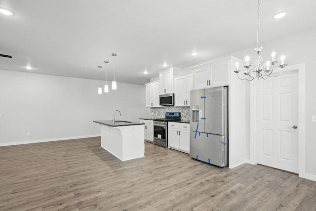 406 Barton Pl, Neosho, MO 64850 - kitchen with stainless steel appliances, dark countertops, open floor plan, light wood-type flooring, and tasteful backsplash