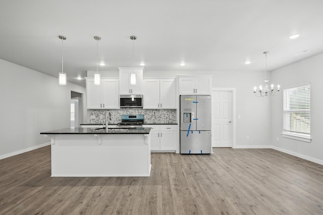 406 Barton Pl, Neosho, MO 64850 - kitchen featuring stainless steel appliances, dark countertops, light wood finished floors, and recessed lighting