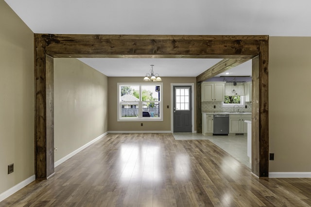 2236 E Logan St, Republic, MO 65738 - unfurnished dining area featuring a chandelier, wood finished floors, baseboards, and beamed ceiling
