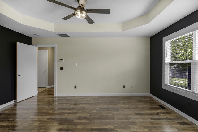 2236 E Logan St, Republic, MO 65738 - spare room featuring a tray ceiling, ceiling fan, wood finished floors, and baseboards