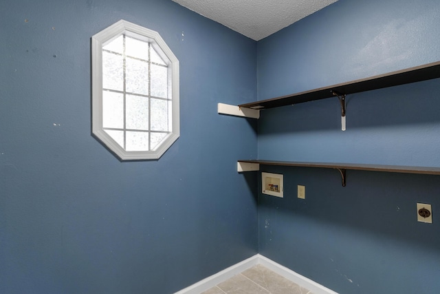 2236 E Logan St, Republic, MO 65738 - laundry area with hookup for an electric dryer, washer hookup, light tile patterned floors, baseboards, and a textured ceiling