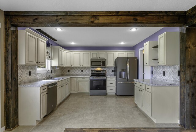 2236 E Logan St, Republic, MO 65738 - kitchen featuring appliances with stainless steel finishes, a sink, tasteful backsplash, light stone counters, and beamed ceiling