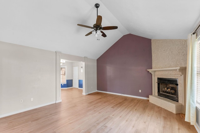 4501 N 16th St, Ozark, MO 65721 - unfurnished living room with ceiling fan, a fireplace with raised hearth, lofted ceiling, and light wood-type flooring
