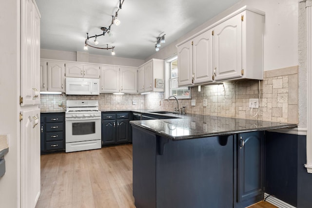 4501 N 16th St, Ozark, MO 65721 - kitchen featuring white appliances, white cabinetry, light wood-style flooring, and a peninsula