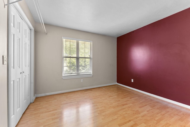 4501 N 16th St, Ozark, MO 65721 - unfurnished bedroom with light wood finished floors and a closet