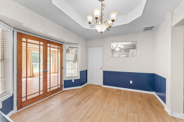 4501 N 16th St, Ozark, MO 65721 - spare room with a chandelier, wood finished floors, french doors, and a raised ceiling